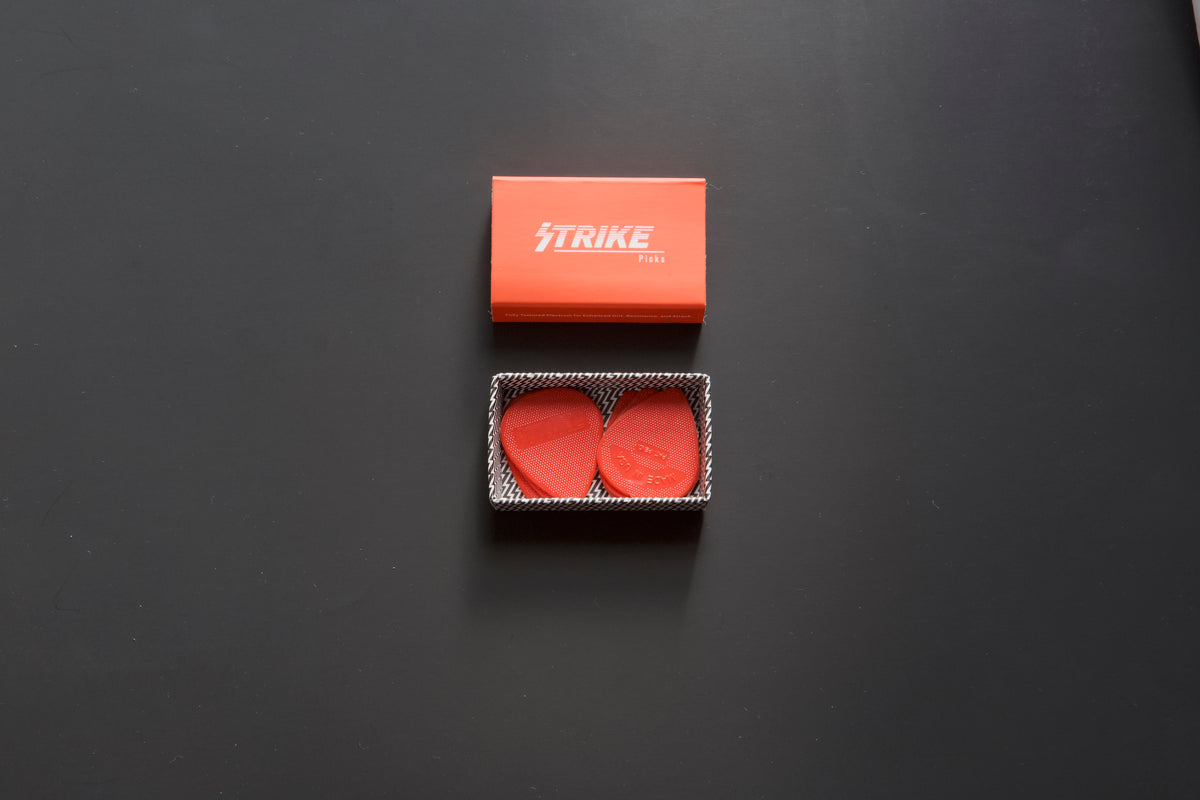 Strike Picks red guitar picks in branded packaging