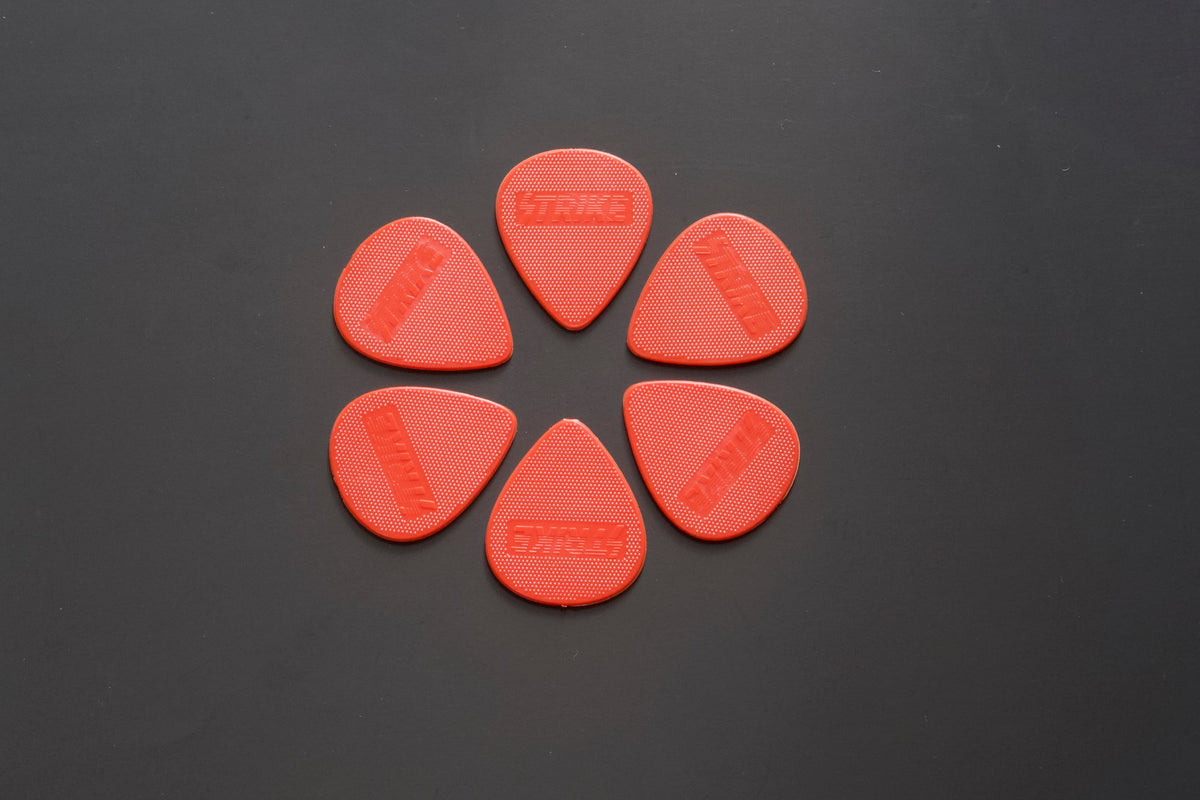 Strike Picks red guitar pick close-up