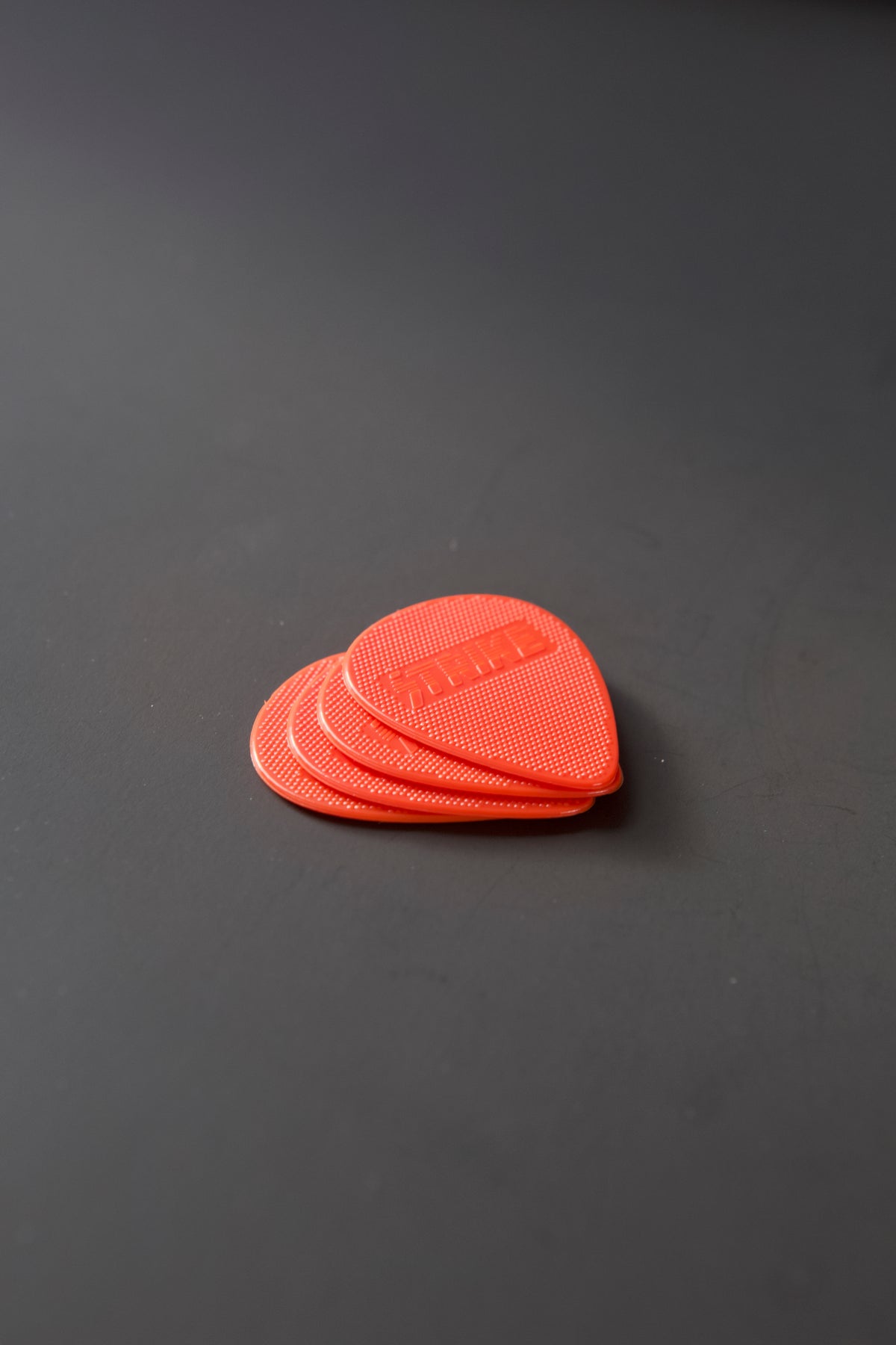Stack of Strike Picks red guitar picks
